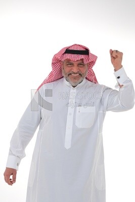 Saudi man raising his fist while smiling with different facial and hand gestures, a young Saudi man wearing a white dress with a shemagh and headband, white background