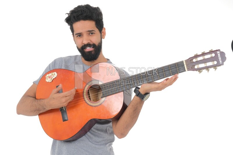 Saudi  man carrying a musical instrument, guitar playing talent, entertainment and singing, white background, Saudi model