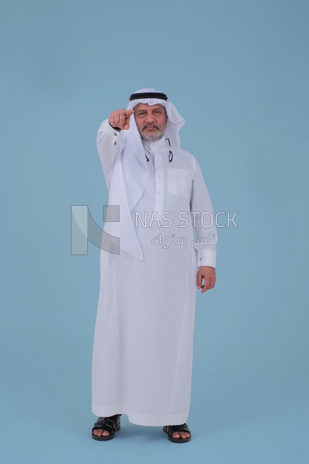 close-up of a Saudi man in traditional Saudi dress, pointing away, Saudi model, white background