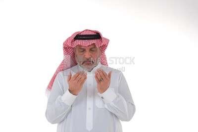 Saudi man wearing a white dress, praying to god, praying on the prayer rug, Islam and worship, white background, Saudi model