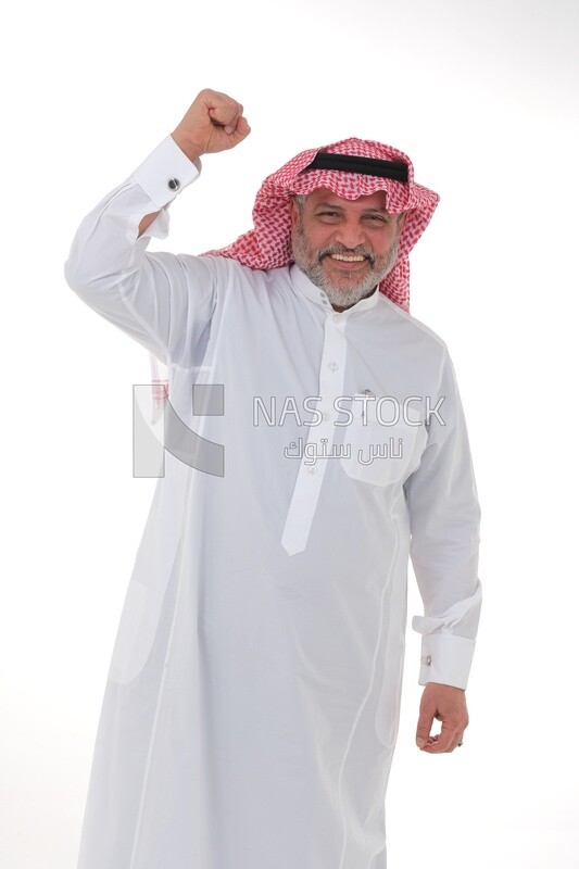 Saudi man raising his fist while smiling with different facial and hand gestures, a young Saudi man wearing a white dress with a shemagh and headband, white background