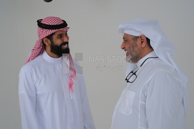 Saudi man spending time with his father standing together, white background, Saudi model