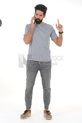 close-up of a Saudi man looking angry, wearing casual clothes, carrying his mobile phone, Saudi model, white background
