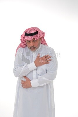 Saudi man placing his hands on his stomach,  abdominal and stomach pain, intestinal disorders, digestive system imbalance, white background