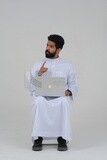 Saudi man sitting in front of a laptop, business feasibility study, white background, Saudi model