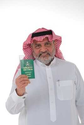 Elderly Saudi man holding a Saudi passport