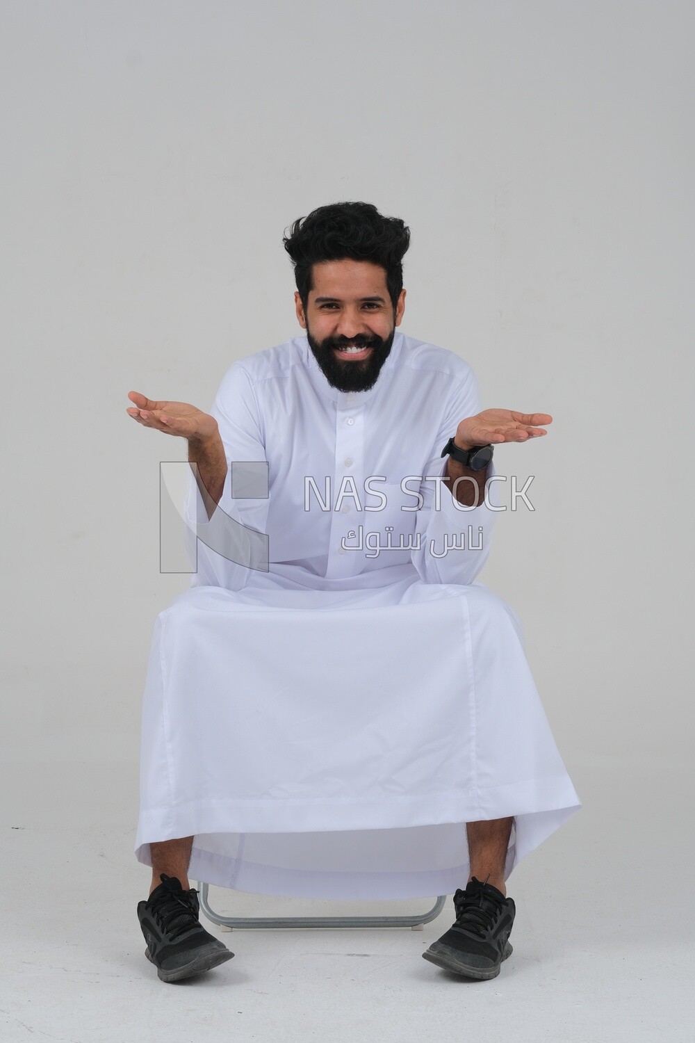 close-up of a Saudi man in traditional Saudi dress, sitting on a chair, Saudi model, white background
