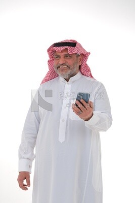 elderly Saudi man using a mobile phone, communicating with individuals, online requests and marketing, social relations, using technical devices, white background