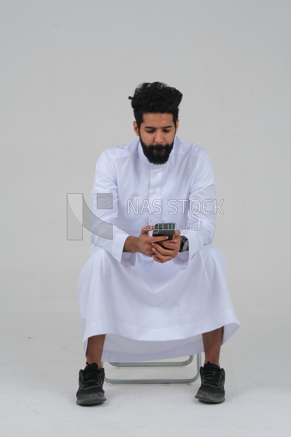 saudi man using a mobile phone, communicating with individuals, online requests and marketing, social relations, using technical devices, white background