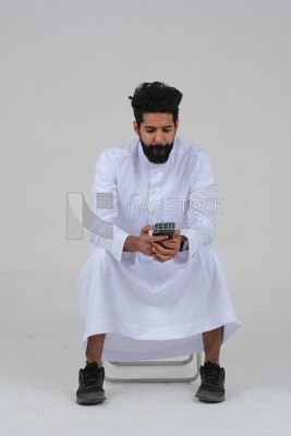 saudi man using a mobile phone, communicating with individuals, online requests and marketing, social relations, using technical devices, white background