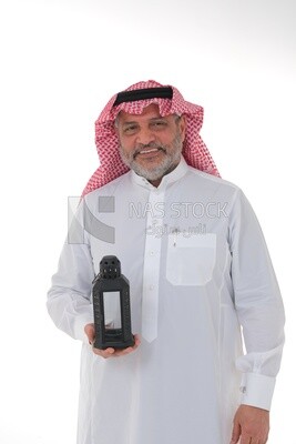 Saudi man holding a Ramadan lantern, Ramadan lantern, the blessed month of Ramadan, lighting and decorations for the month of Ramadan, Ramadan atmosphere, religious occasions