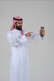 Saudi man using a mobile phone, taking a selfie, communicating with individuals, online requests and marketing, social relations, using technical devices, white background