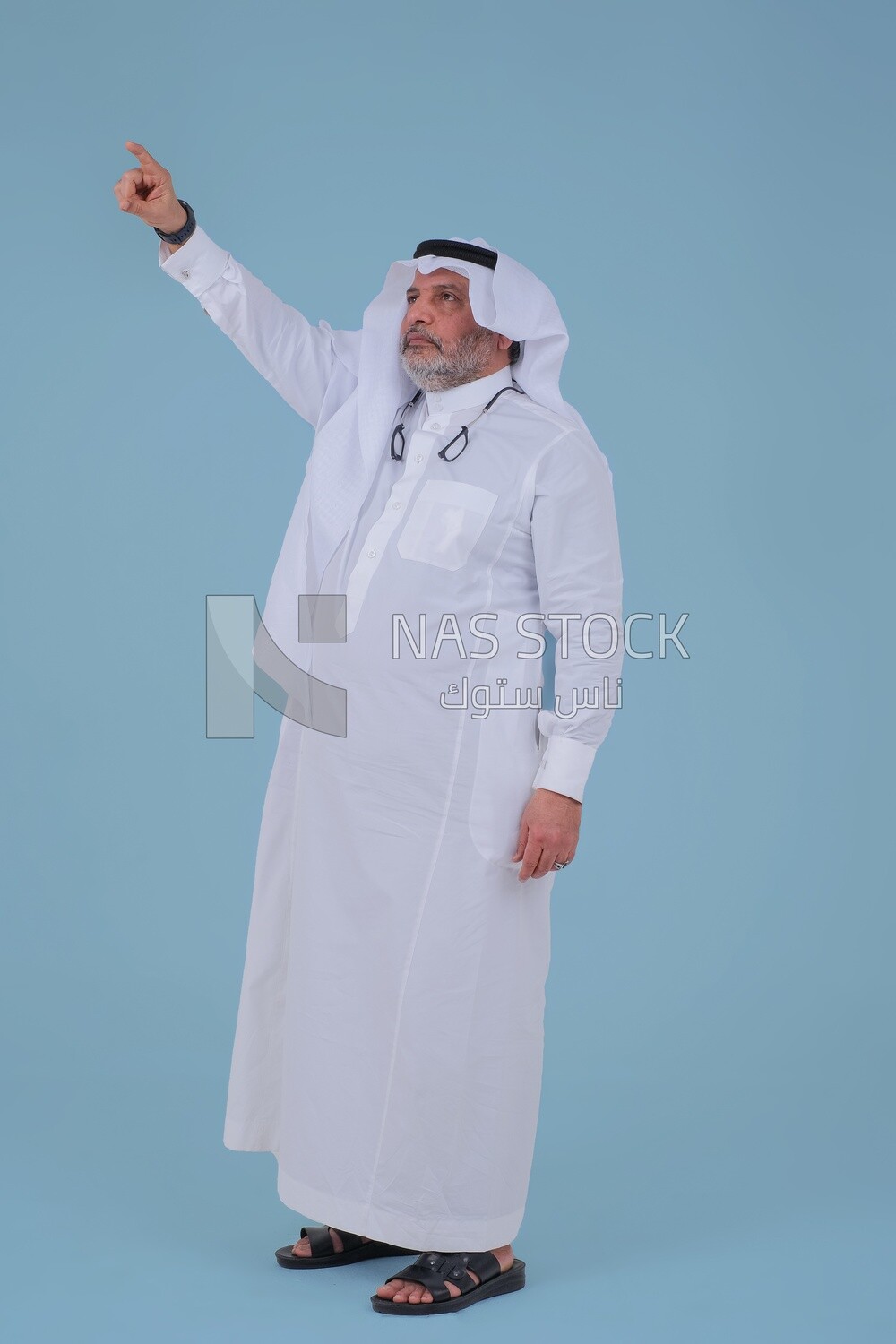 close-up of a Saudi man in traditional Saudi dress, pointing away, Saudi model, white background