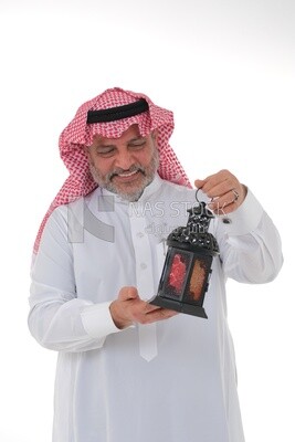 Saudi man holding a Ramadan lantern, Ramadan lantern, the blessed month of Ramadan, lighting and decorations for the month of Ramadan, Ramadan atmosphere, religious occasions