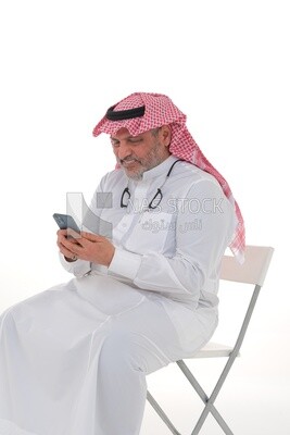 elderly Saudi man using a mobile phone, communicating with individuals, online requests and marketing, social relations, using technical devices, white background