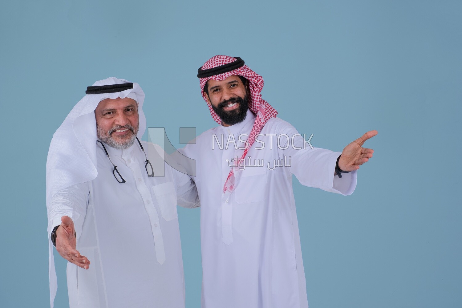 two Saudi men pointing at something, identifying a target, pointing towards something, finger movement and gestures