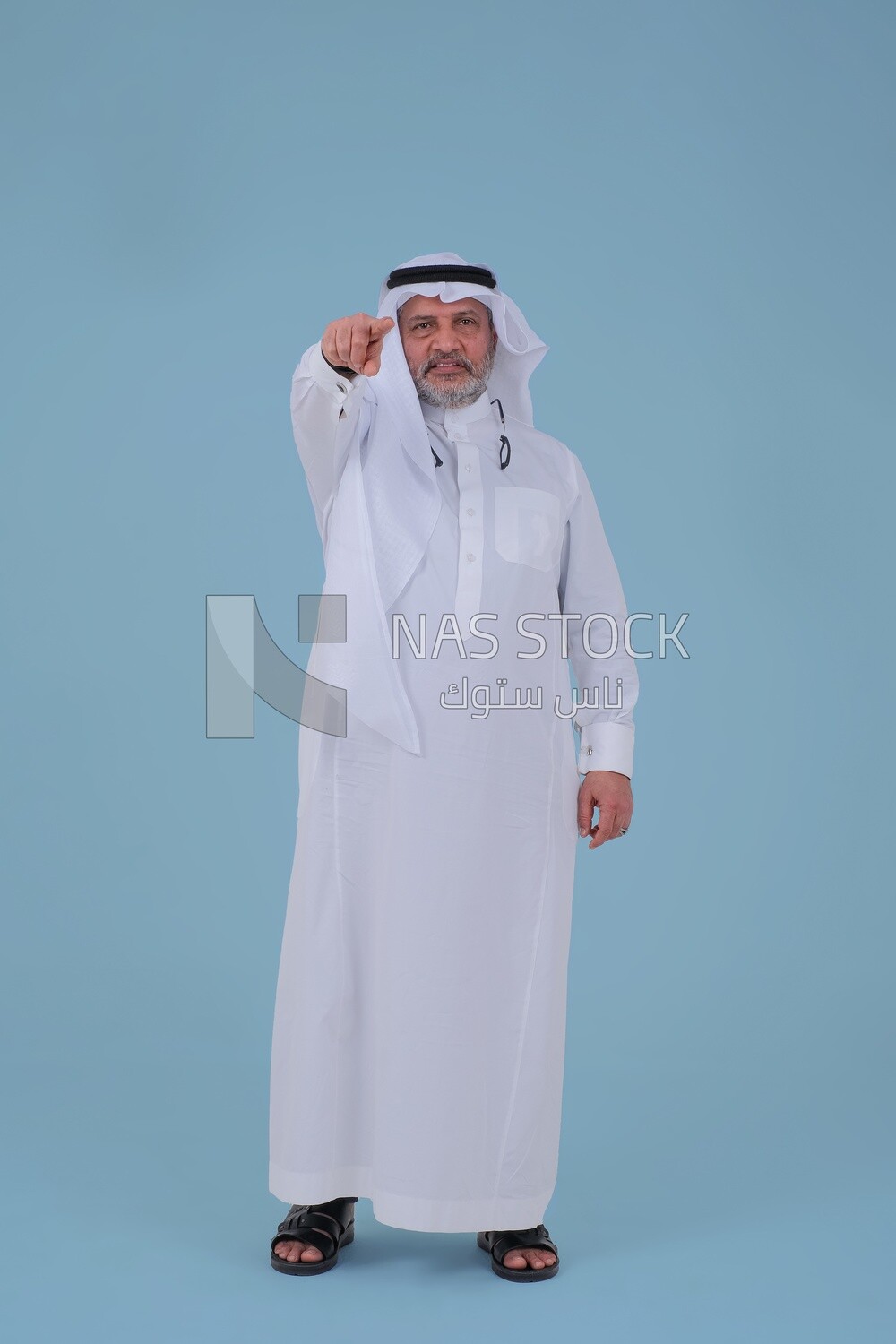close-up of a Saudi man in traditional Saudi dress, pointing away, Saudi model, white background