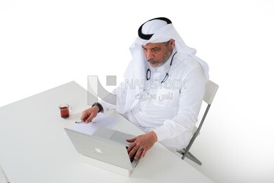 منظر علوى لرجل عجوز سعودي مسن يجلس أمام جهاز كمبيوتر محمول ، دراسة جدوى الأعمال ، موديل سعودي