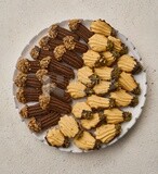 Top view for Petit four sweets on a solid background