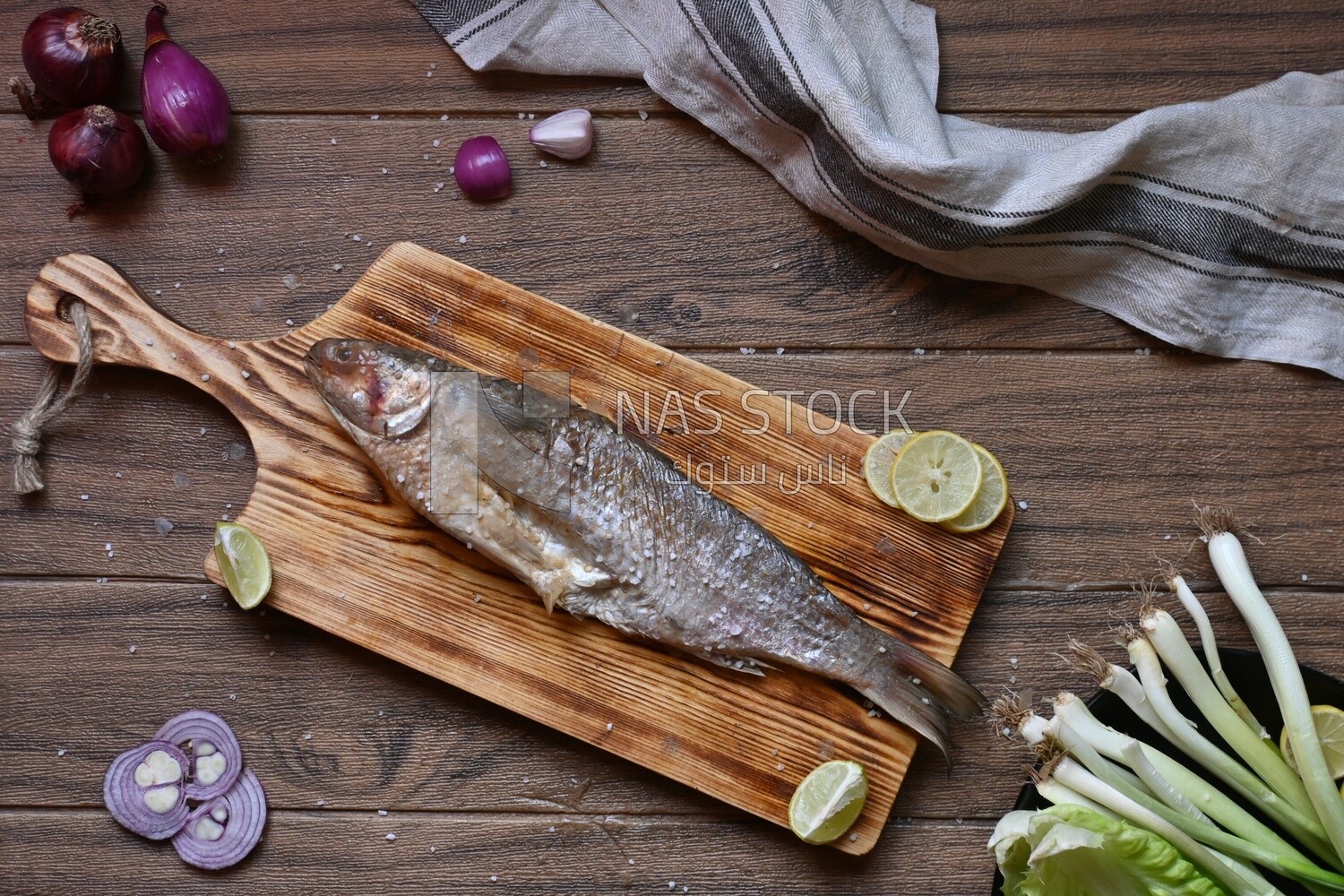 Smoked herring on a Cutting and Serving Board, lemon and onion, traditional food, smoked fish