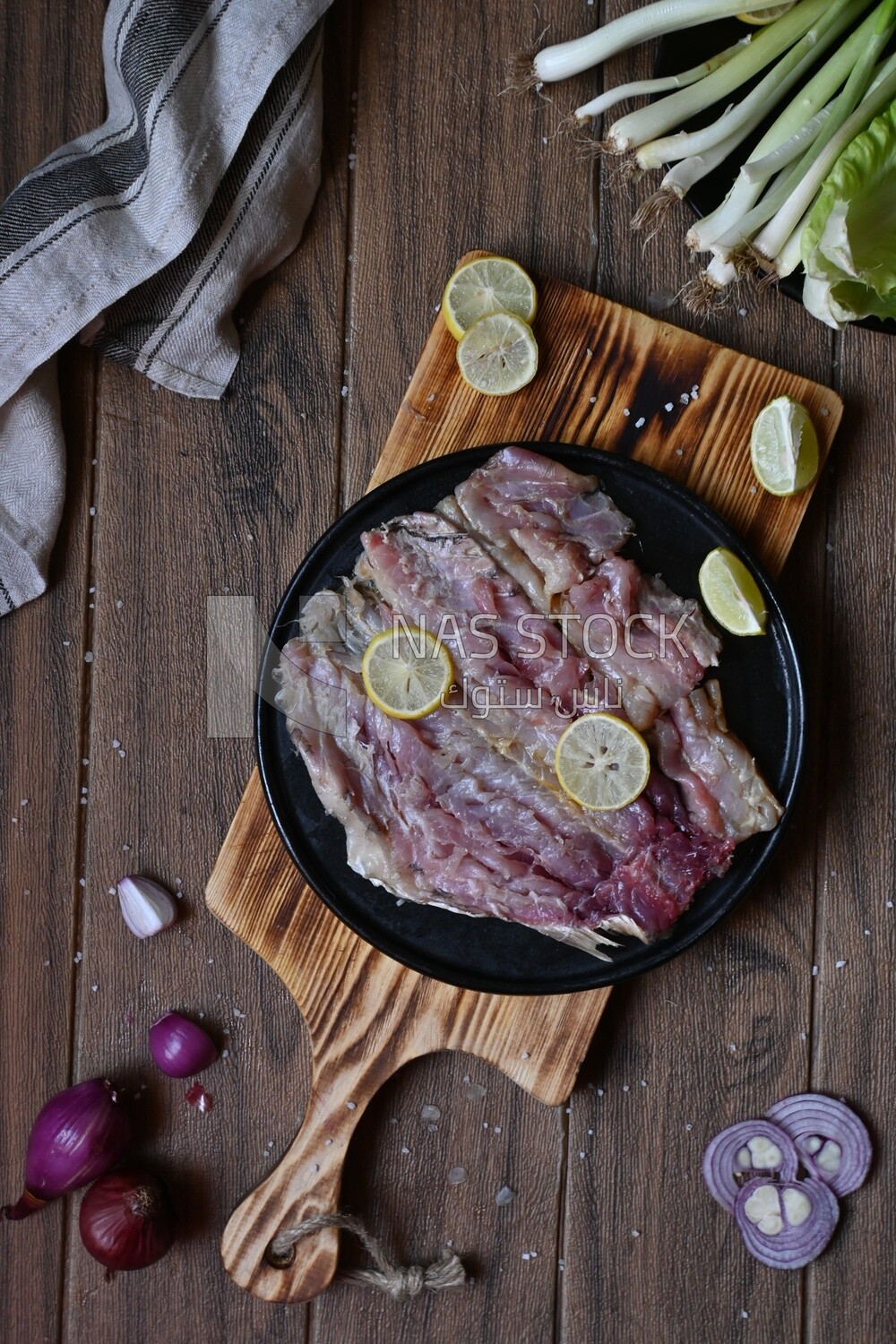 Herring fillet with lemon on a plate on a Cutting and Serving Board, traditional food, smoked fish