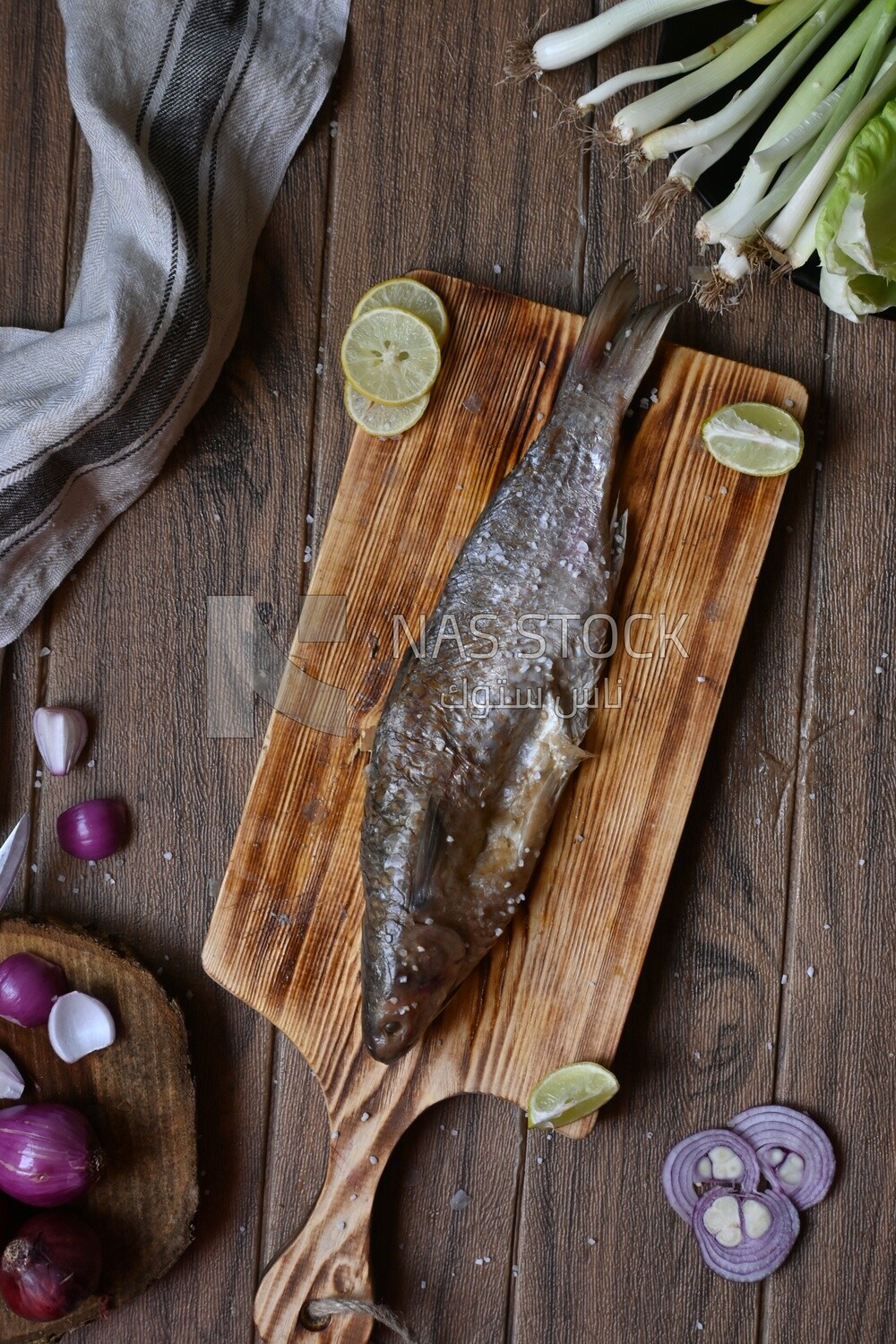 Smoked herring on a Cutting and Serving Board, lemon and onion, traditional food, smoked fish