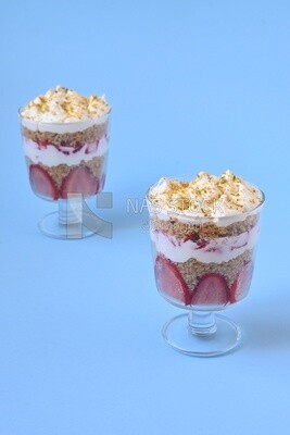 Kunafa with strawberries and cream on isolated background
