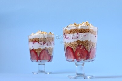 Two cups of Kunafa with strawberries on isolated background
