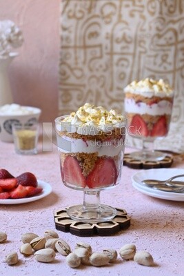 Two cups of Kunafa with strawberries and cream