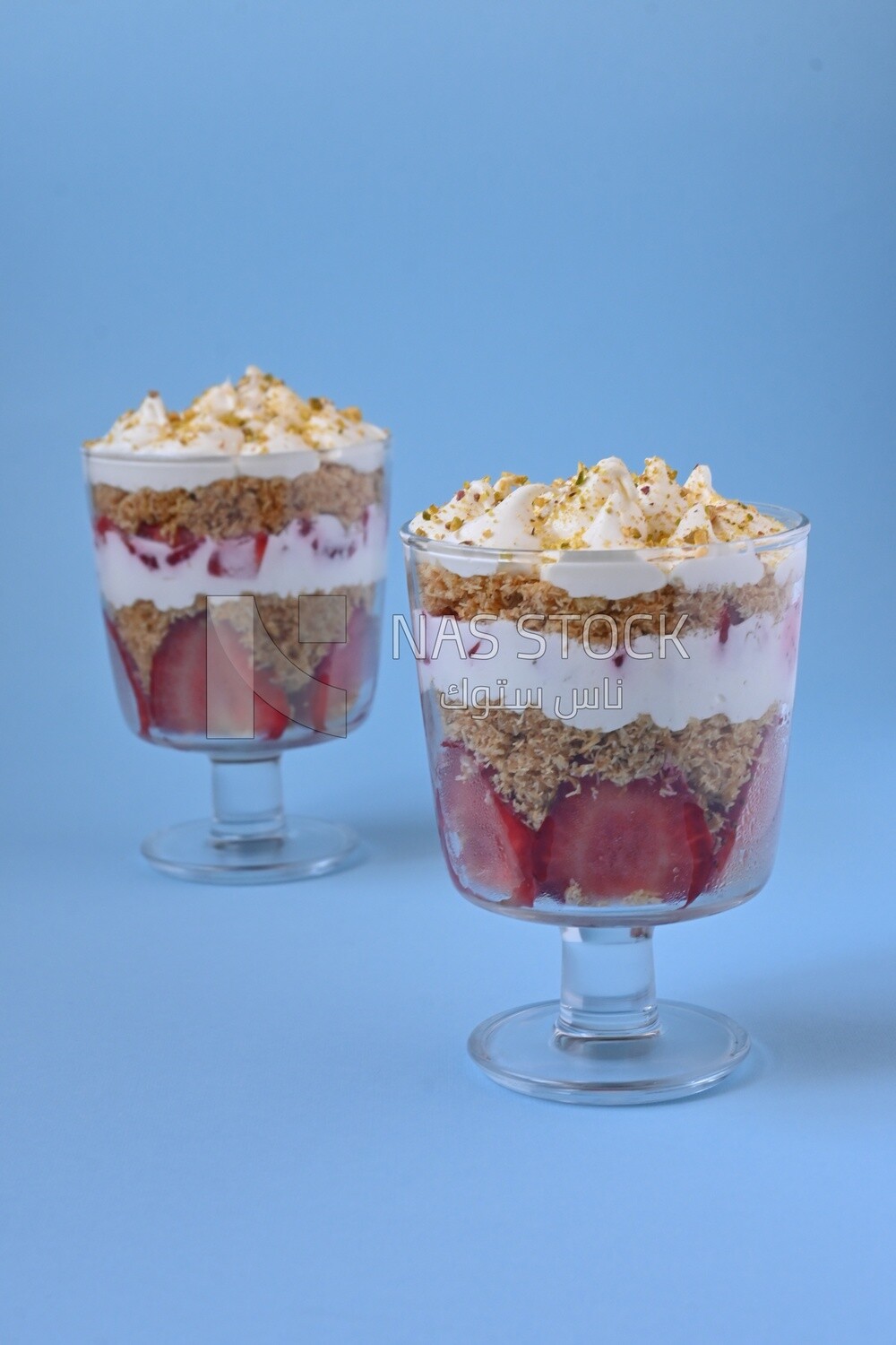 Two cups of Kunafa with strawberries on isolated background