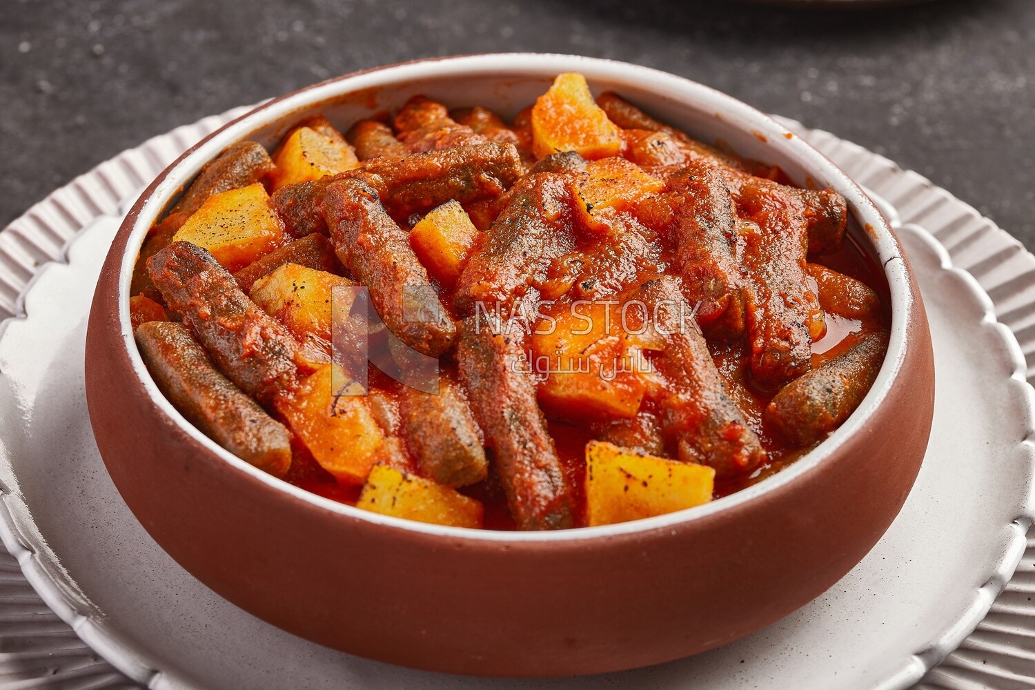 Rice kofta with potatoes, dipped in red tomato sauce