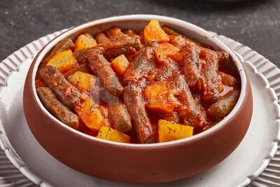 Rice kofta with potatoes, dipped in red tomato sauce