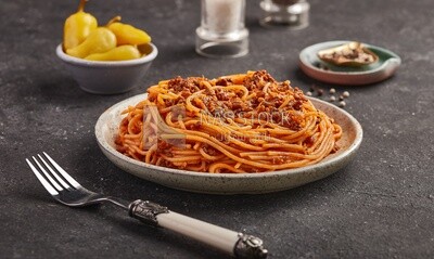 Dining table with spaghetti pasta with minced meat