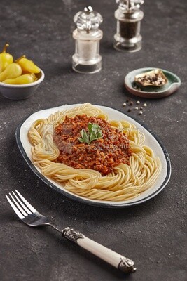 Dining table with spaghetti with minced meat