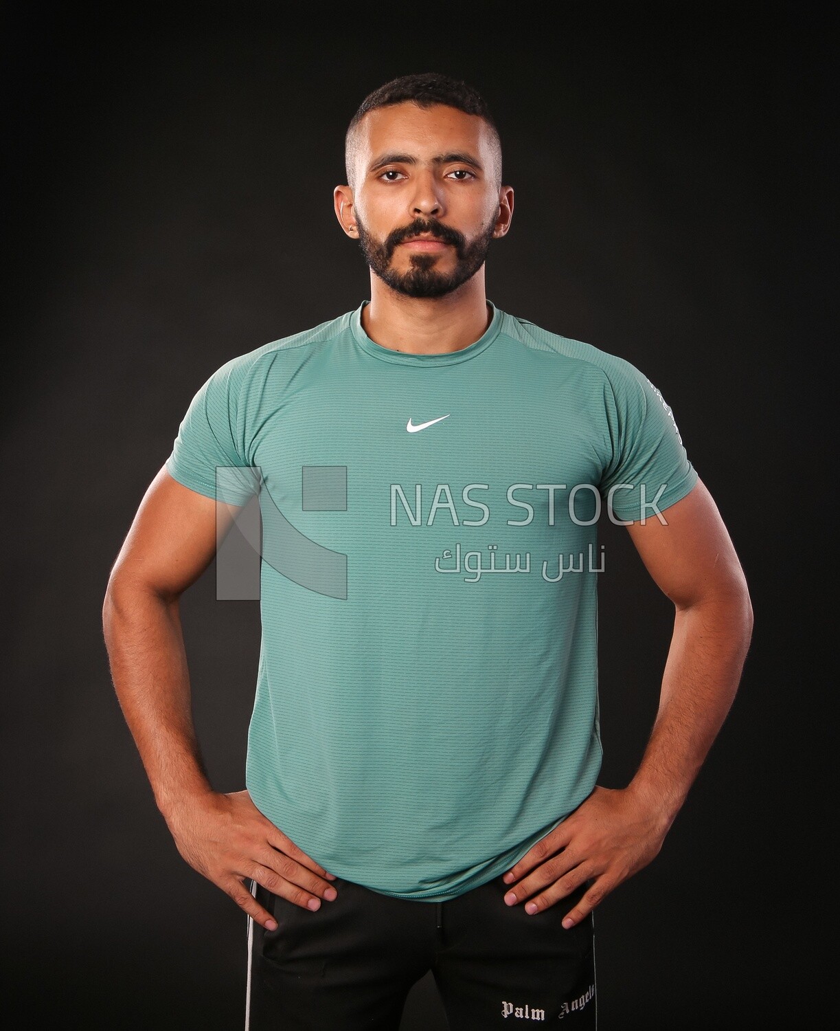 A man standing on a black background
