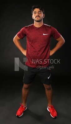 A man standing on a black background