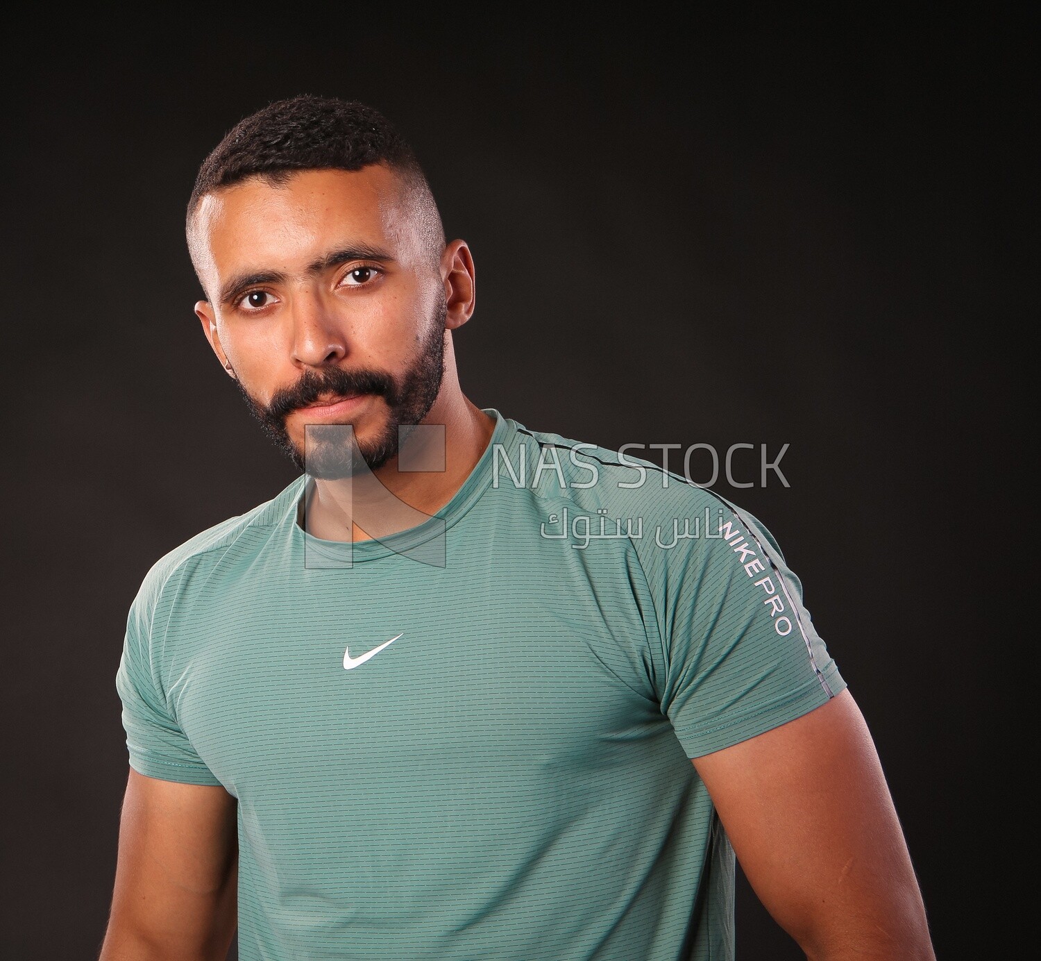 A man standing on a black background