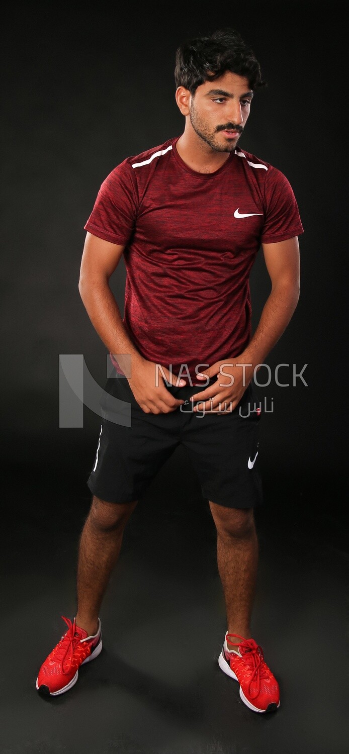 A man standing on a black background