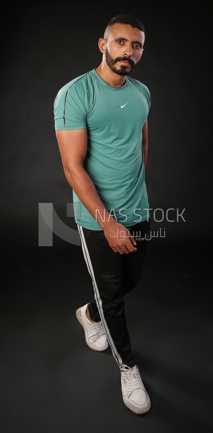 A man standing on a black background