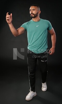 A man standing on a black background