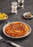 Dining table with spaghetti with minced meat