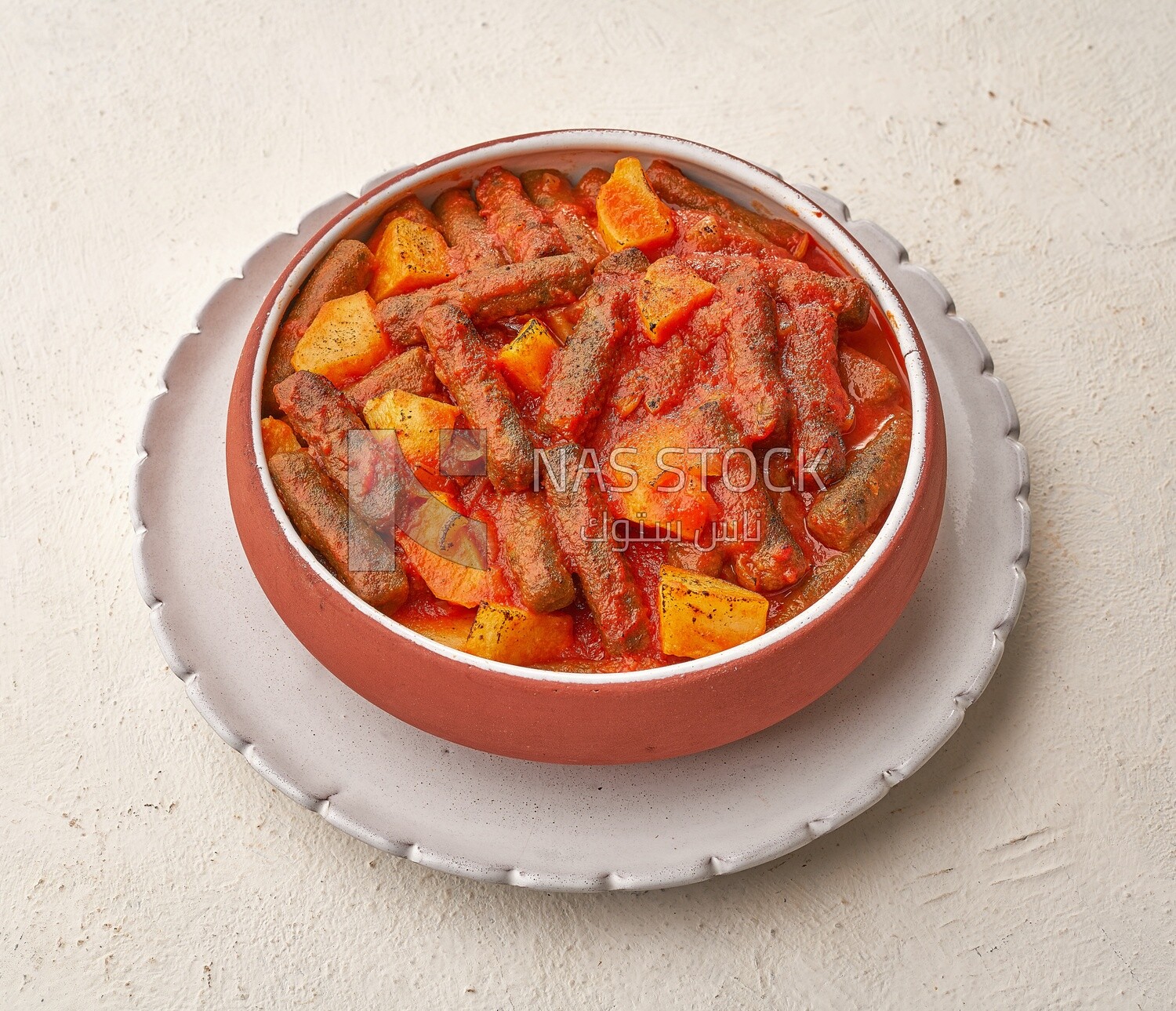 Rice kofta with potatoes, dipped in red tomato sauce