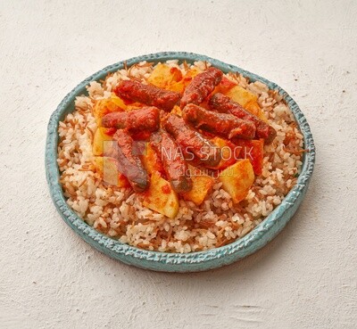 Rice kofta dish with potatoes, on a solid background
