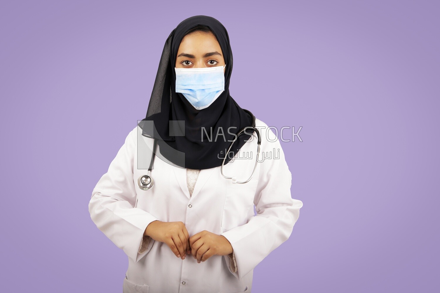 A woman doctor wearing a black hijab