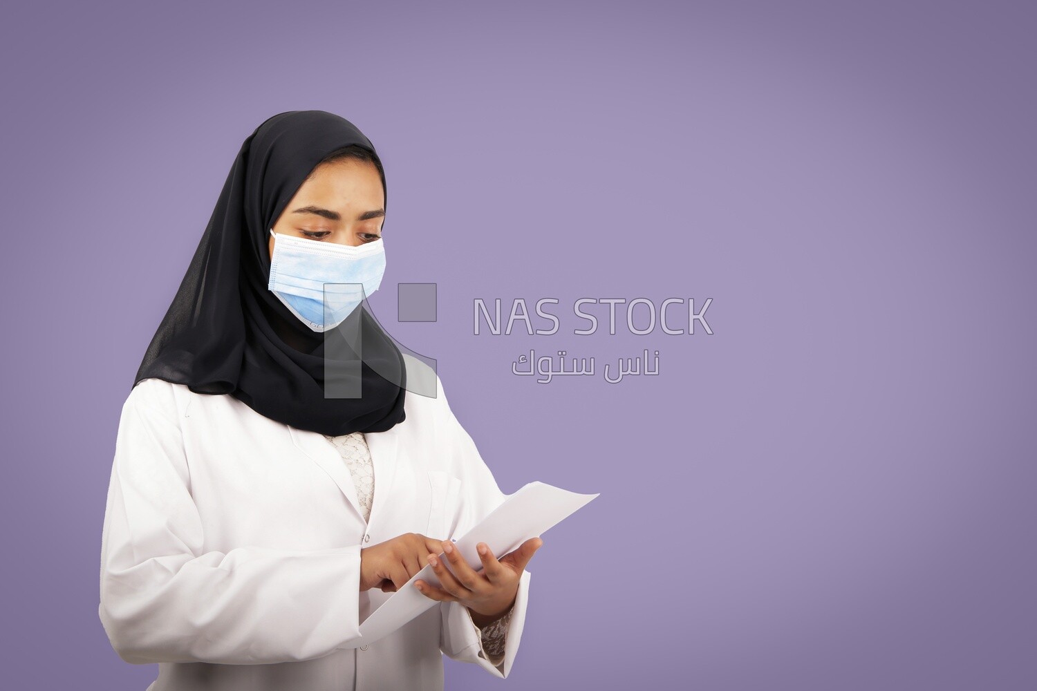 A woman doctor wearing a black hijab