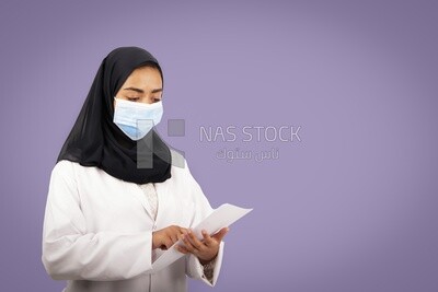 A woman doctor wearing a black hijab