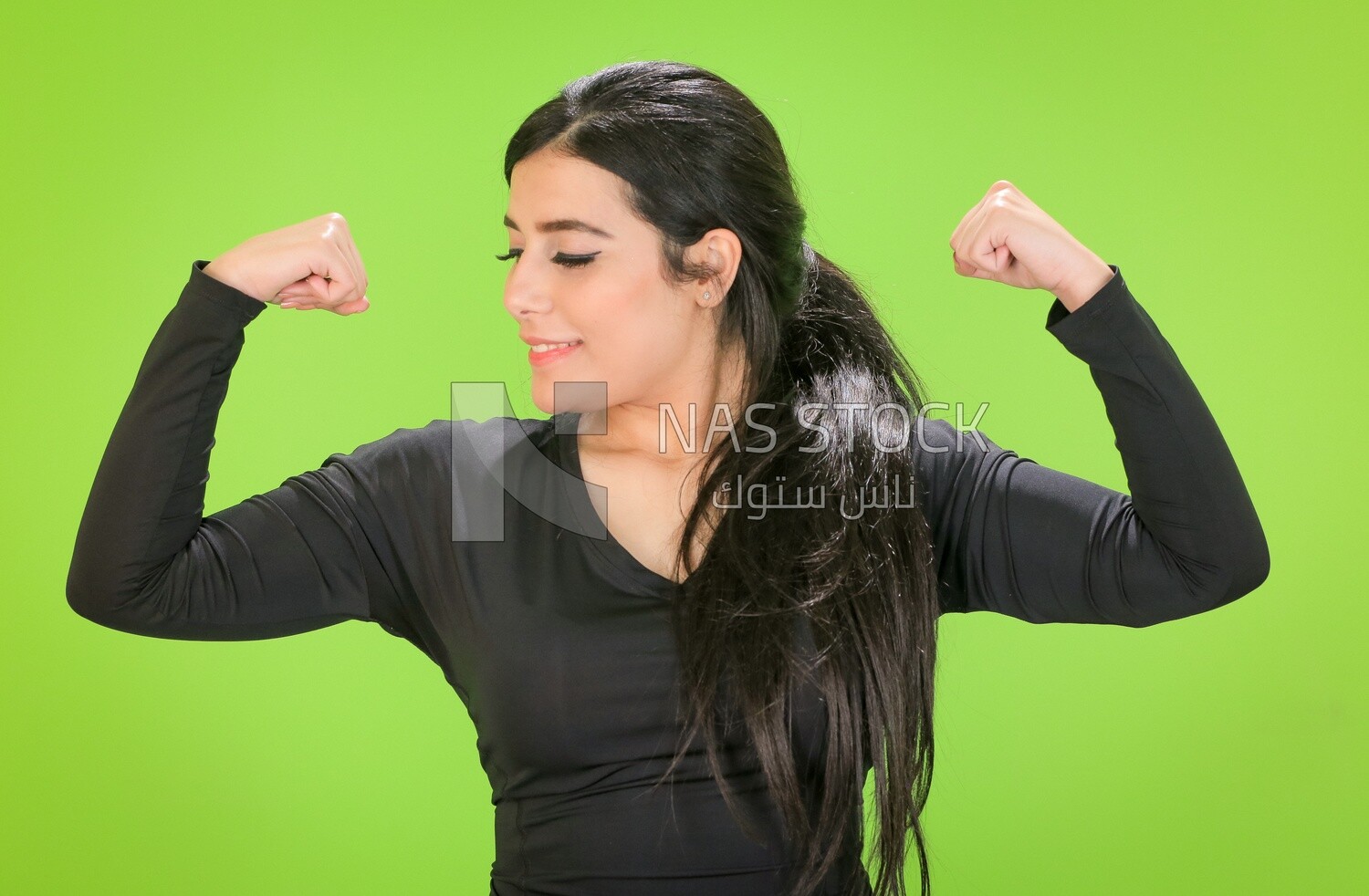 A woman looking at her muscles