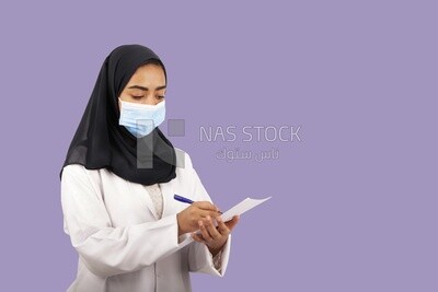 A woman doctor wearing a black hijab