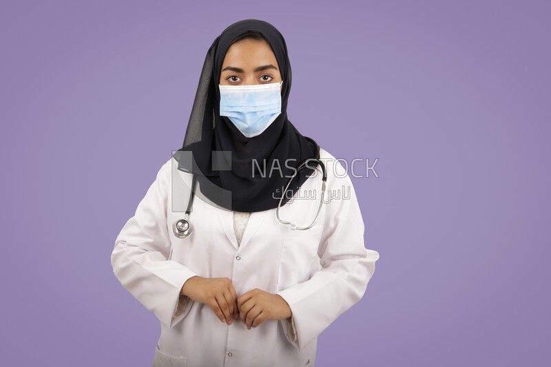 A woman doctor wearing a black hijab