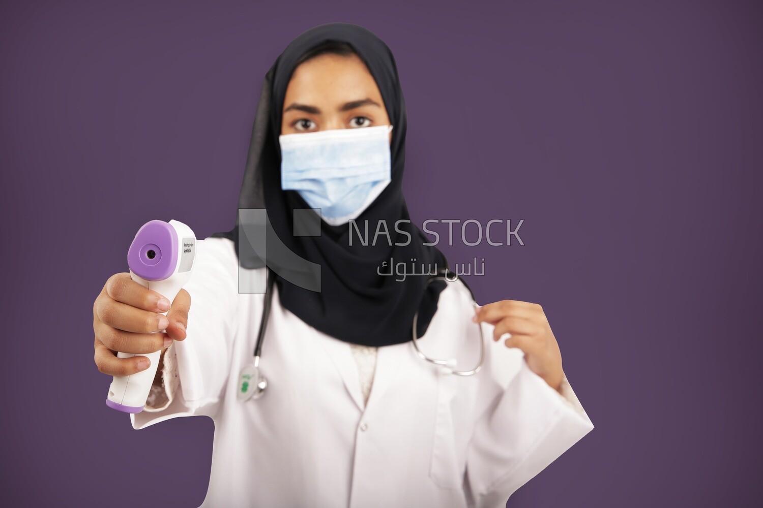 A woman doctor wearing a black hijab